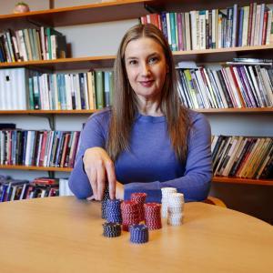 Brooke Rollins sits at a desk with gambling chips.