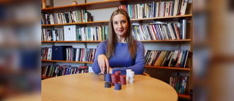 Brooke Rollins sits at a desk with gambling chips.