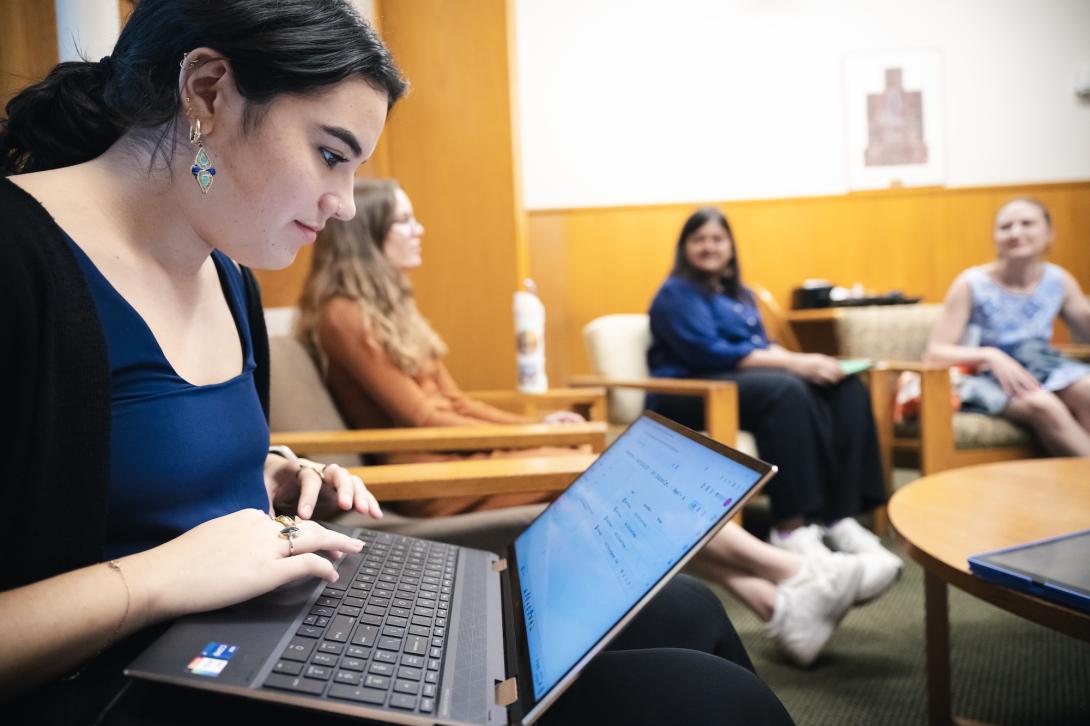 Graduate Students gather in a circle in the common room
